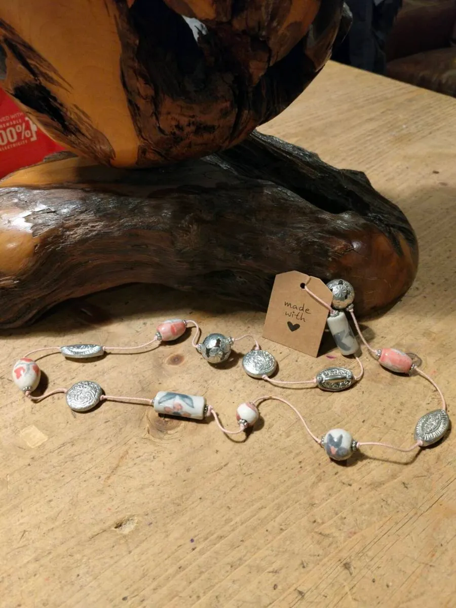 This handmade necklace features a combination of c - Image 3