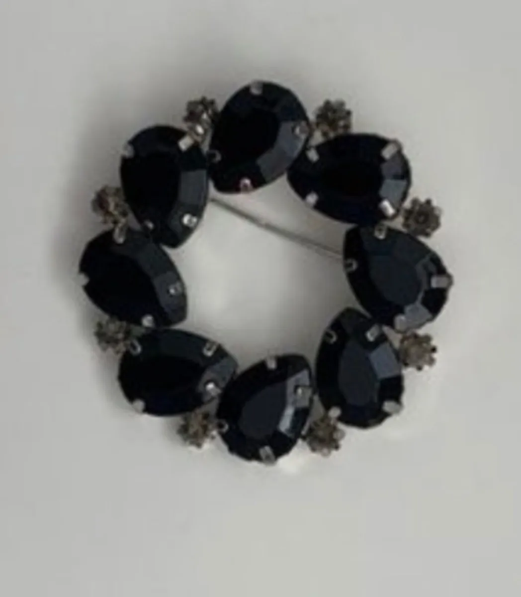 vintage silver-toned brooch with black rhinestone