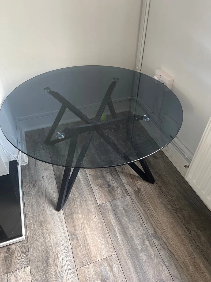 Round smoked glass coffee table – black metal base - Image 1