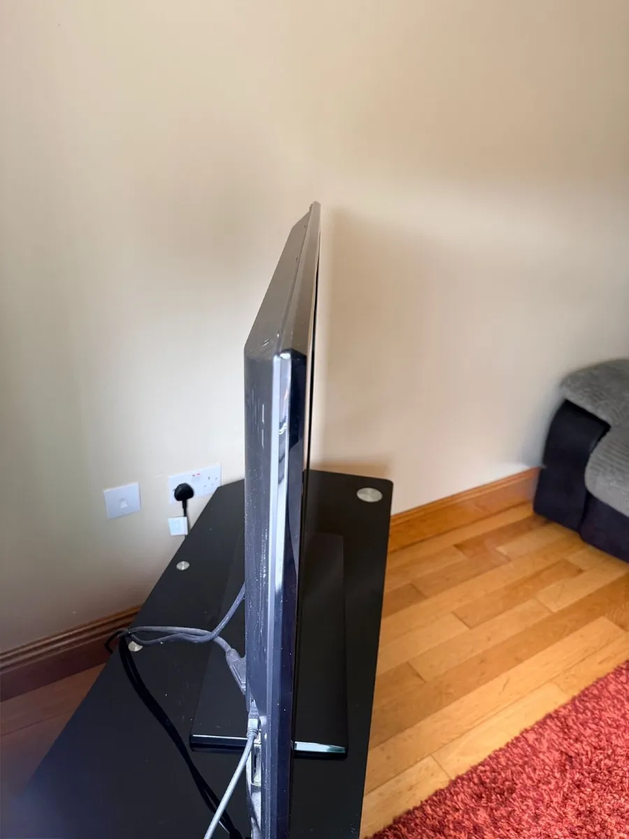 TV and TV Stand - Image 1