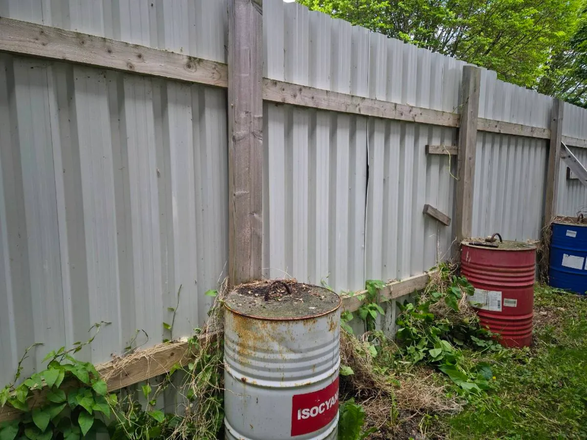 Concrete barrels and posts for site fence