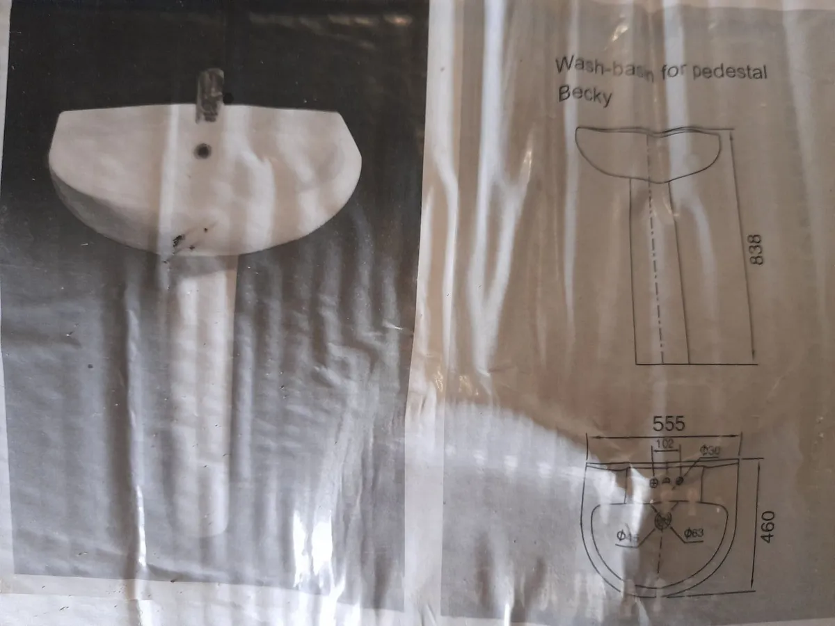 Bathroom sink and toilet - Image 1