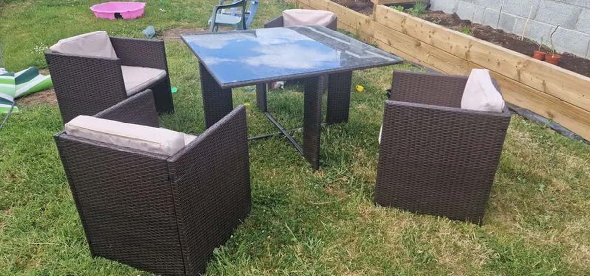 Rattan glass top table and 4 chairs - Image 1