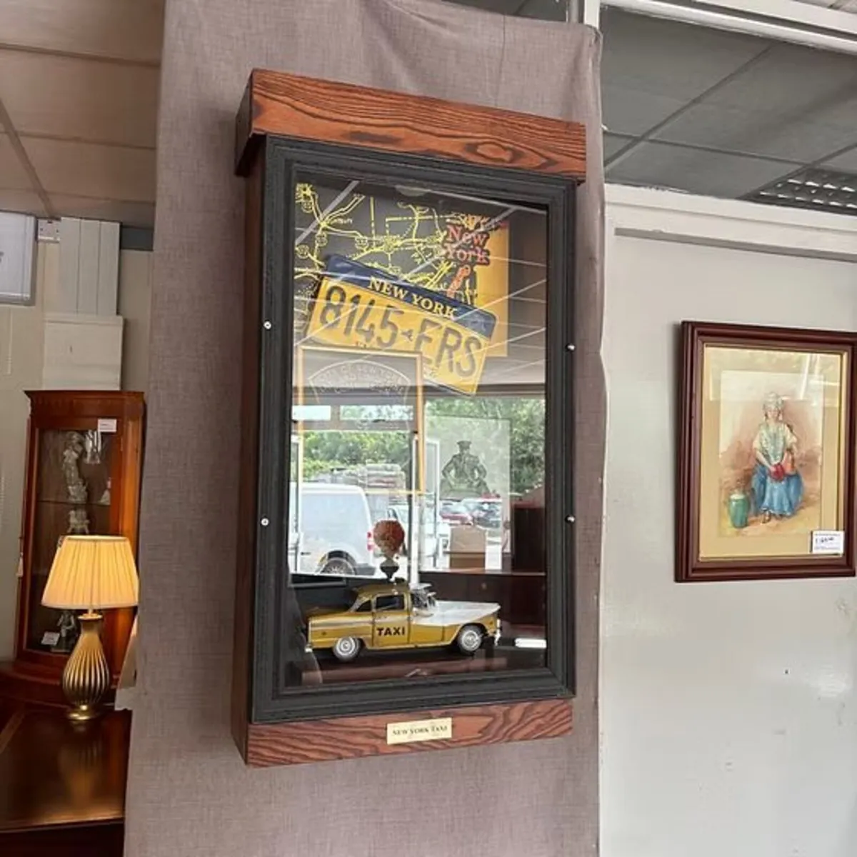 A cased diorama of items relating to New York taxi