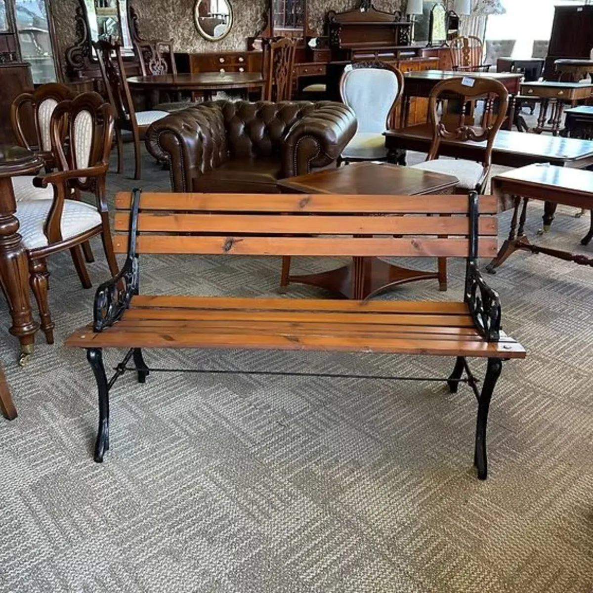 A powder coated cast metal ended garden bench.