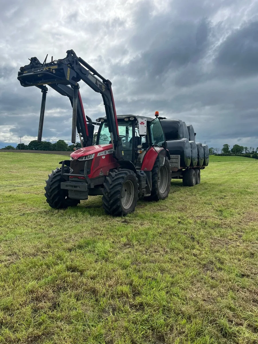 Hauling bales and stacking - Image 1