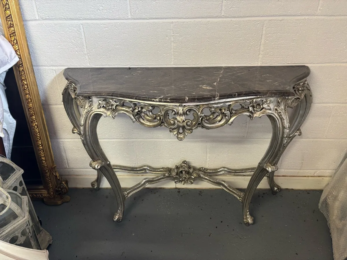 Silver gilt console table with dark marble top