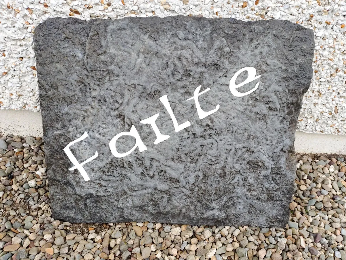 FAILTE HAND CARVED LISCANNOR STONE. - Image 1