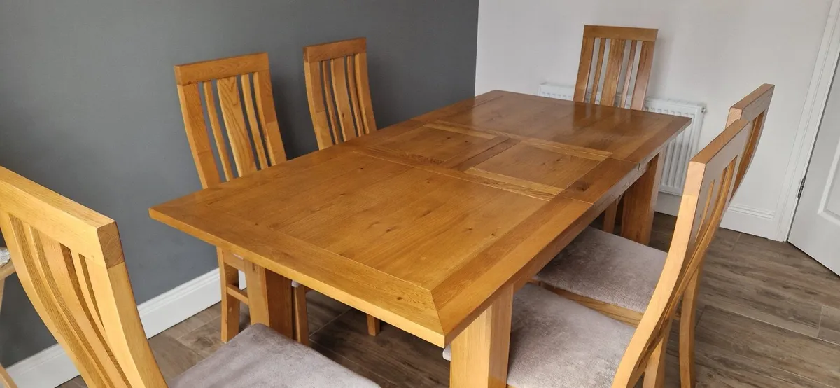 Solid oak extendable kitchen table and chairs - Image 1