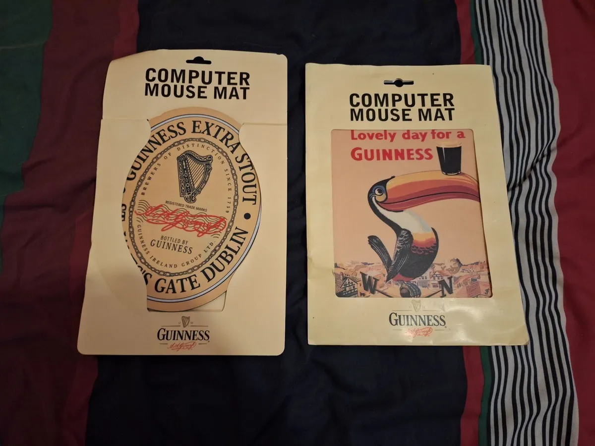 A pair of Guinness mouse mats
