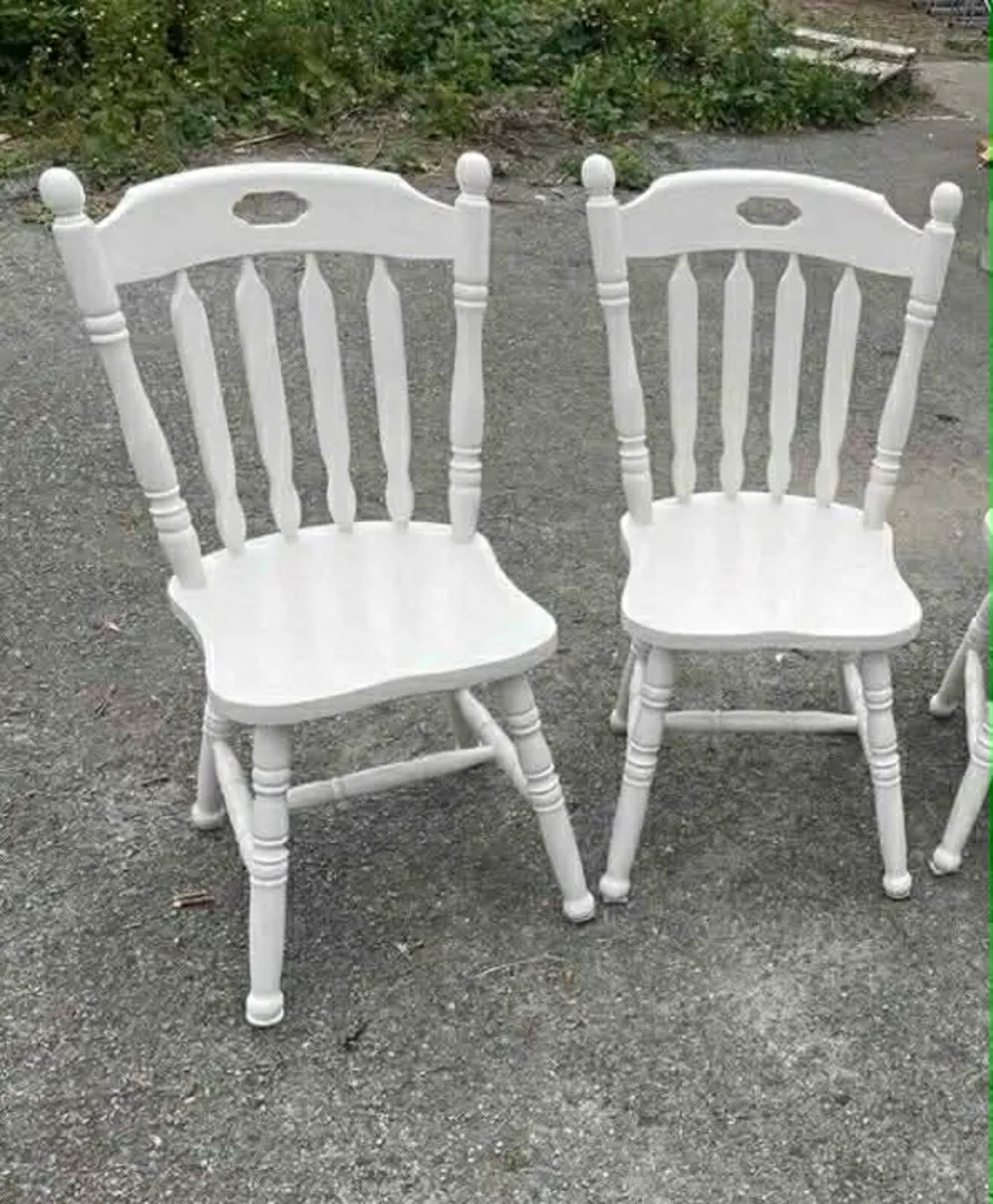 2 white wooden chairs