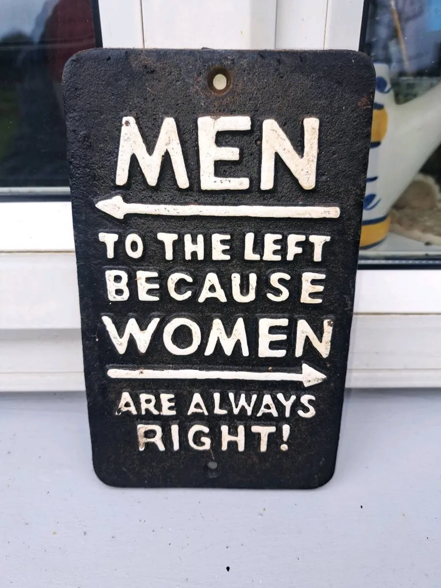 Men to left cast iron sign