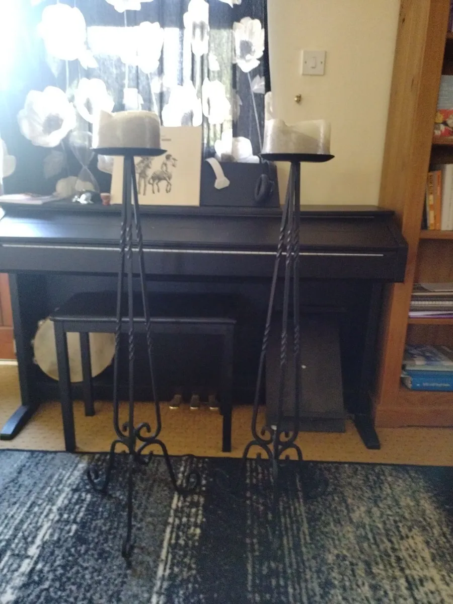 Two cast iron candles sticks