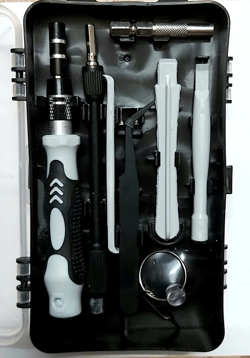 Box of screwdriver bits and phone accessories - Image 1
