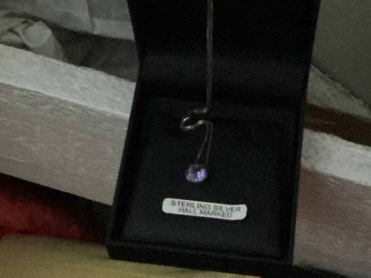 Sterling silver chain with a purple stone
