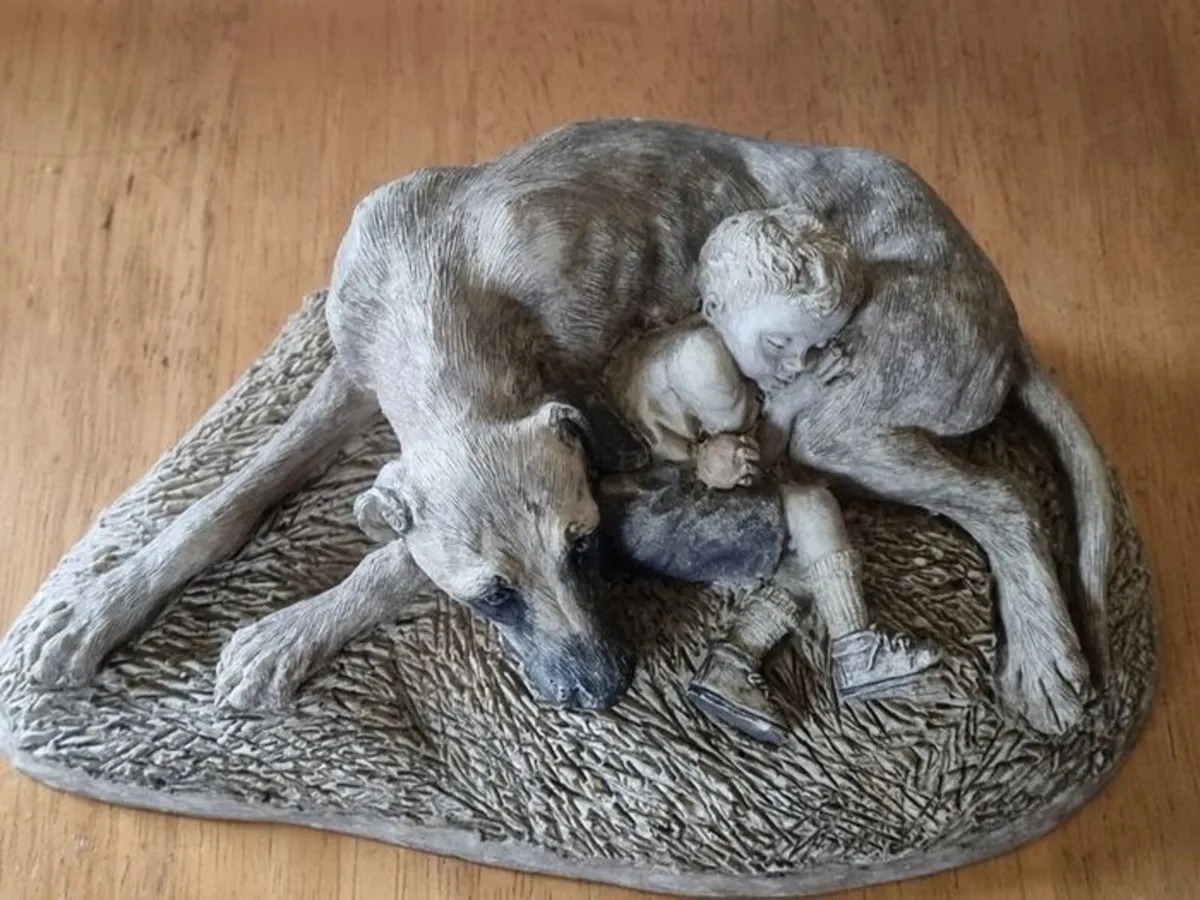 Sculpture of a boy sleeping with a dog - Image 1
