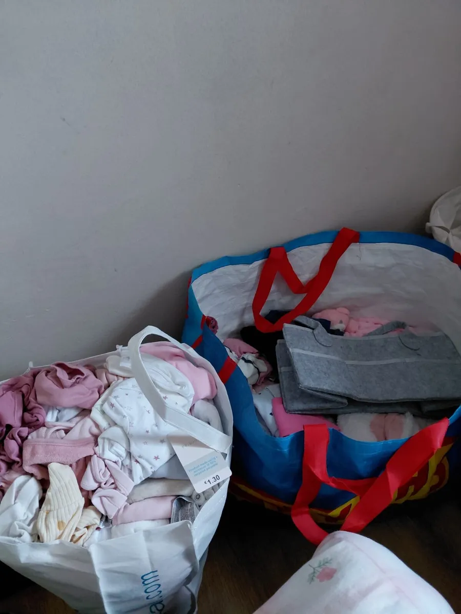 Two bags girls clothes and a 3 in 1 buggy