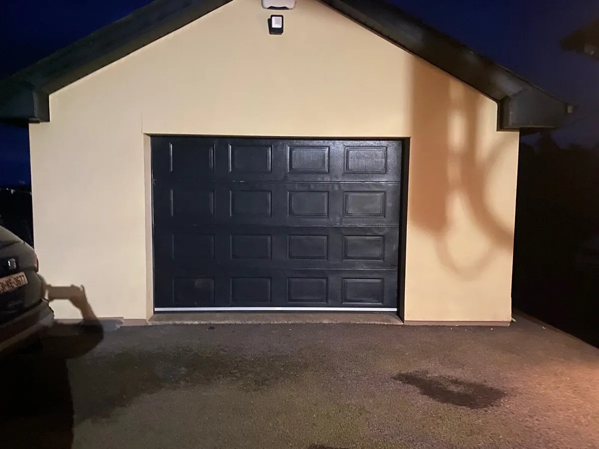 Black up and over electric garage door - Image 1