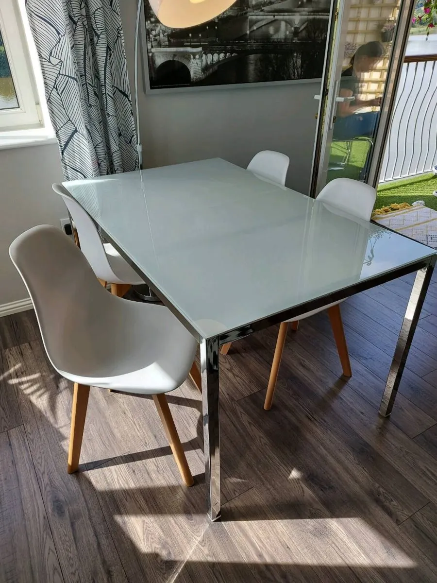 Four white dining chairs