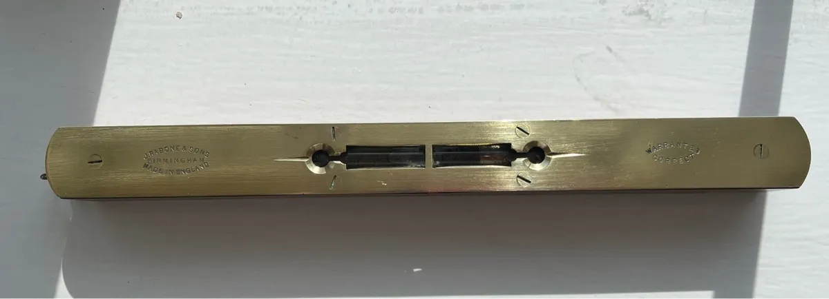 Early 1900s Antique spirit level and a vintage saw - Image 1