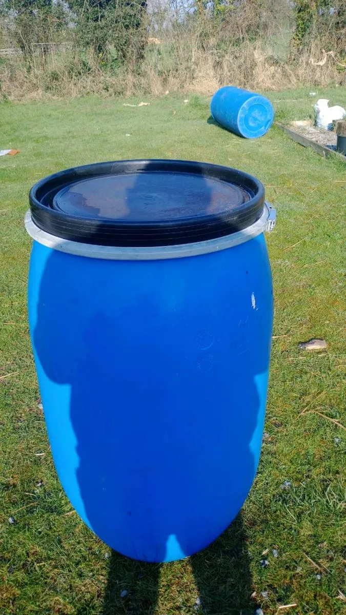 blue plastic barrels. - Image 1