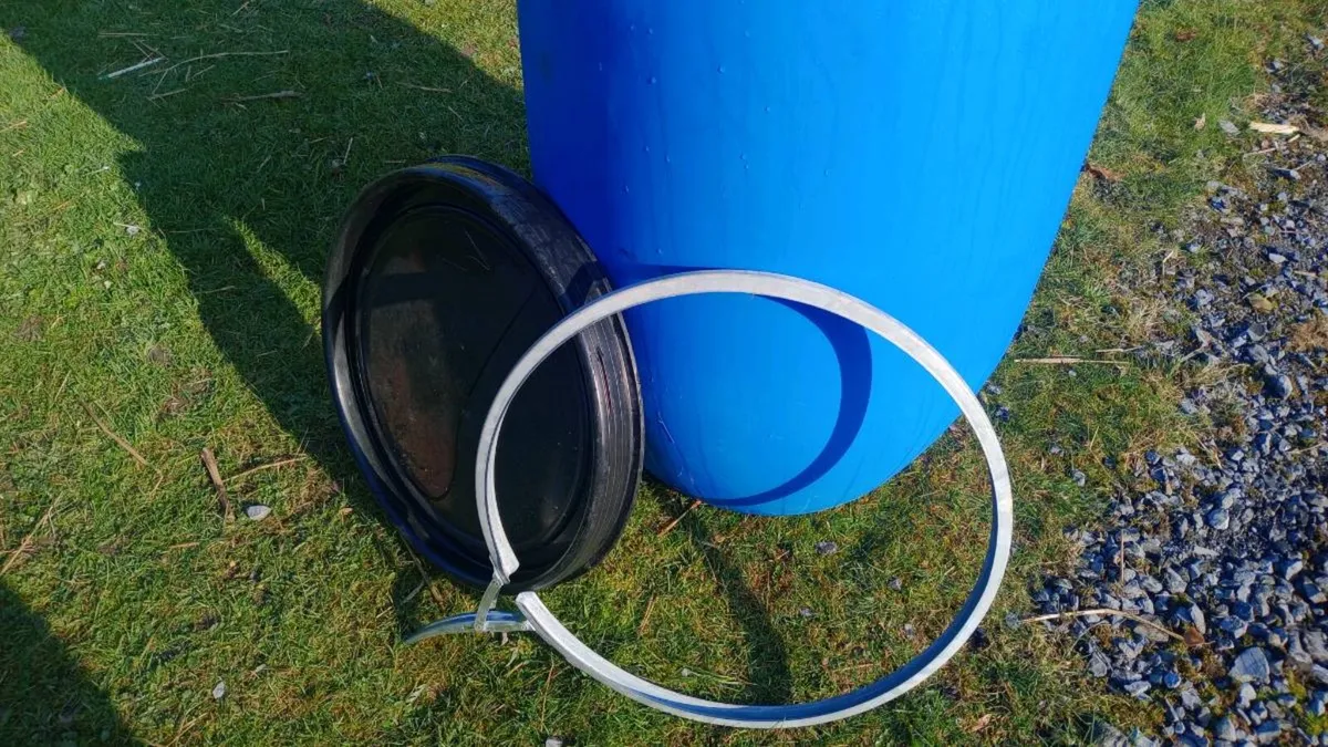 blue plastic barrels. - Image 3