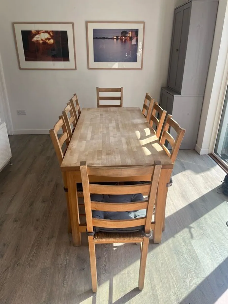 Solid oak dining table and 8 chairs with storage drawers - Image 1
