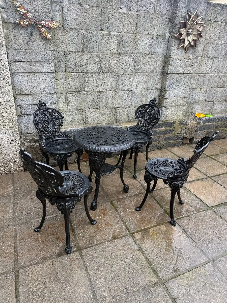 Cast iron table and chairs - Image 1