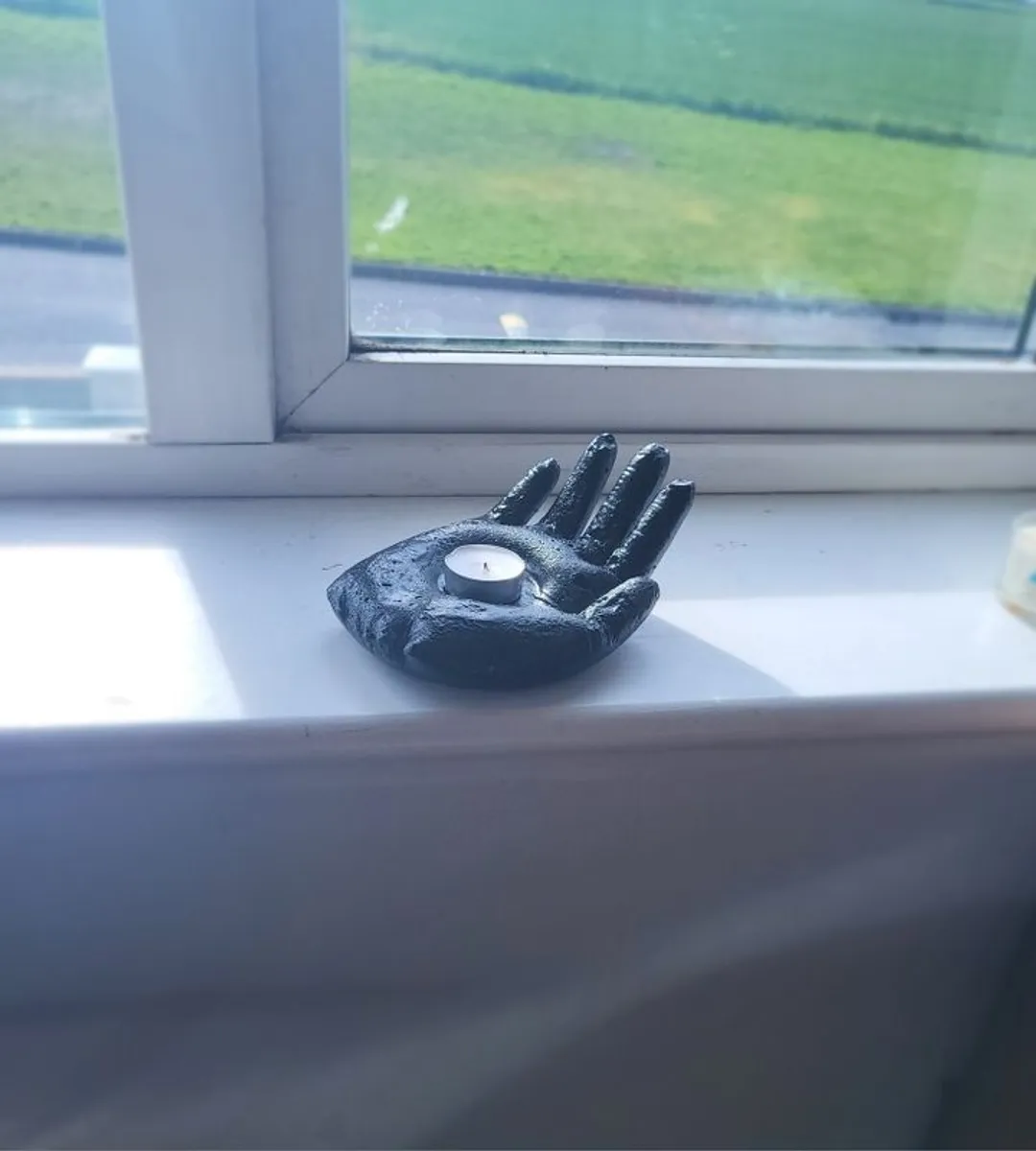 Concrete candle holder in the shape of a hand