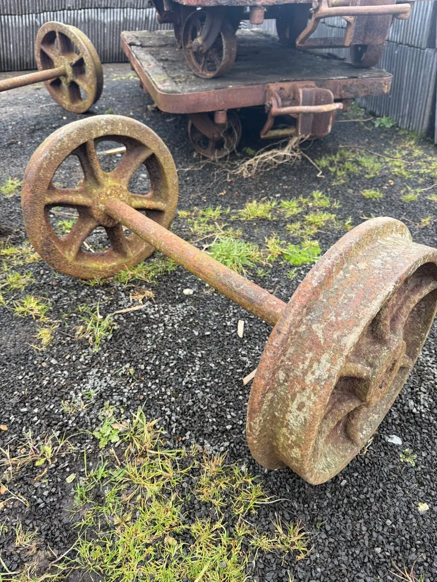 Four old heavy rusty wheels on two axels. - Image 2
