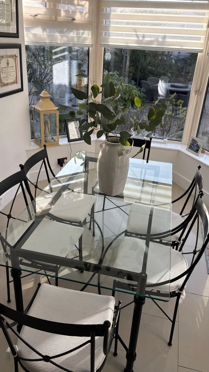 Glass and steel dining table with matching chairs - Image 2