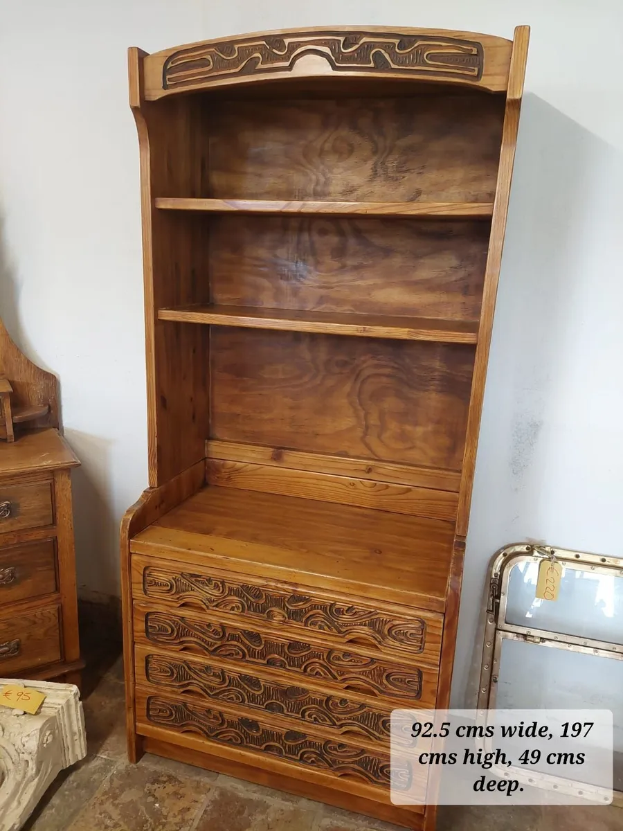 Carved pine bookcase with drawers