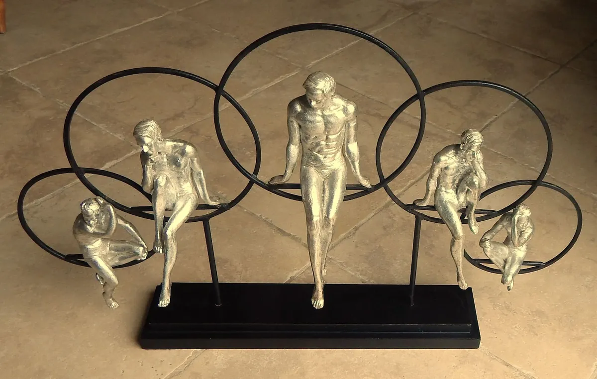 Large Artwork of Male Figurines Inside Metal Rings - Image 1