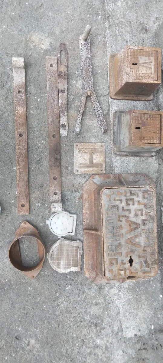 Assortment of Manhole Covers and Gate Brackets - Image 1