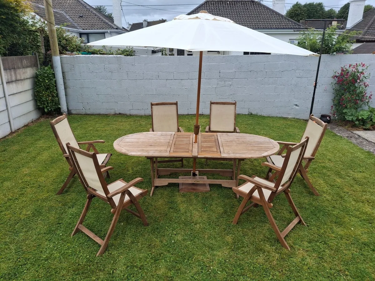 Outdoor table and chairs with parasol. - Image 1