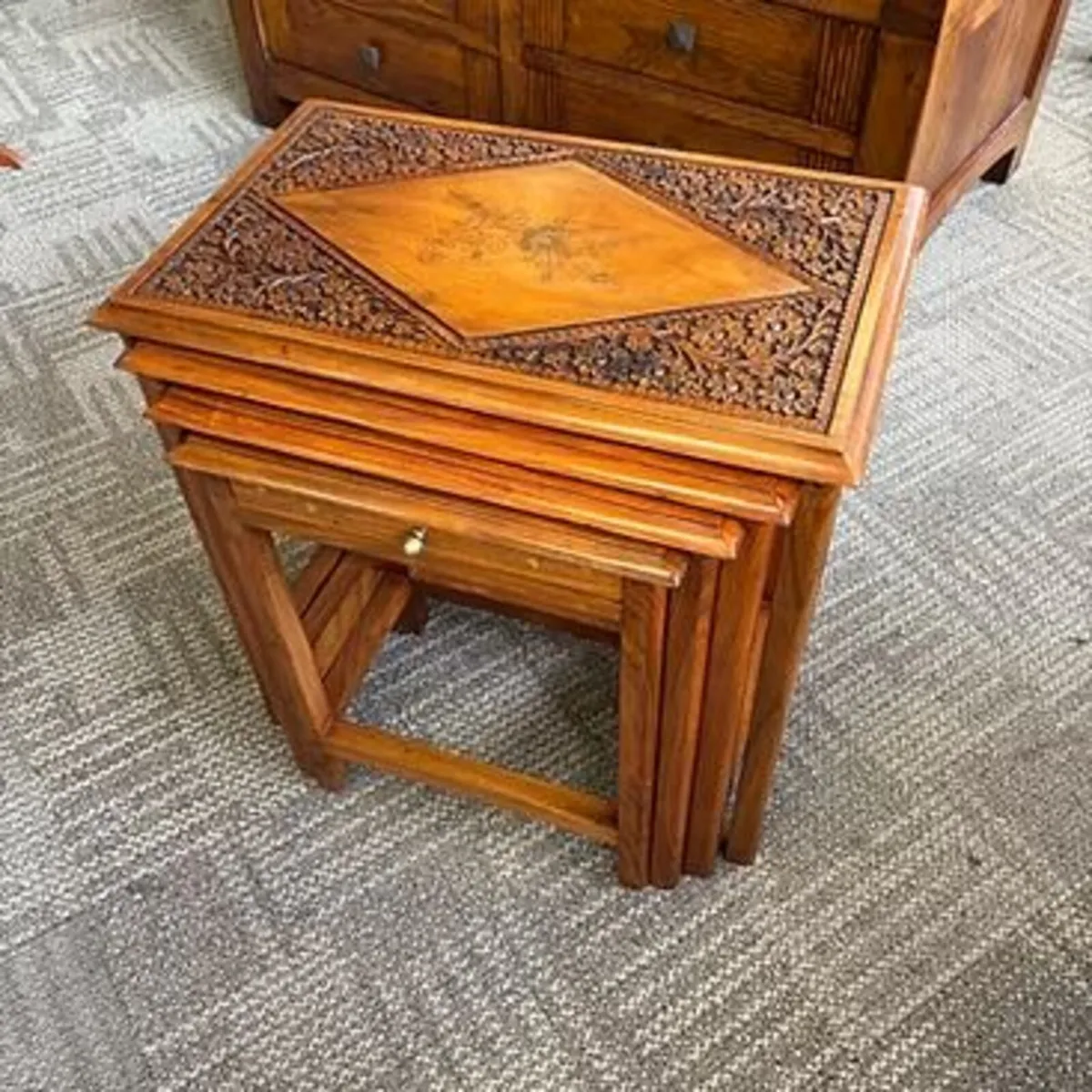 Nest of 4 tables features intricate hand-carvings