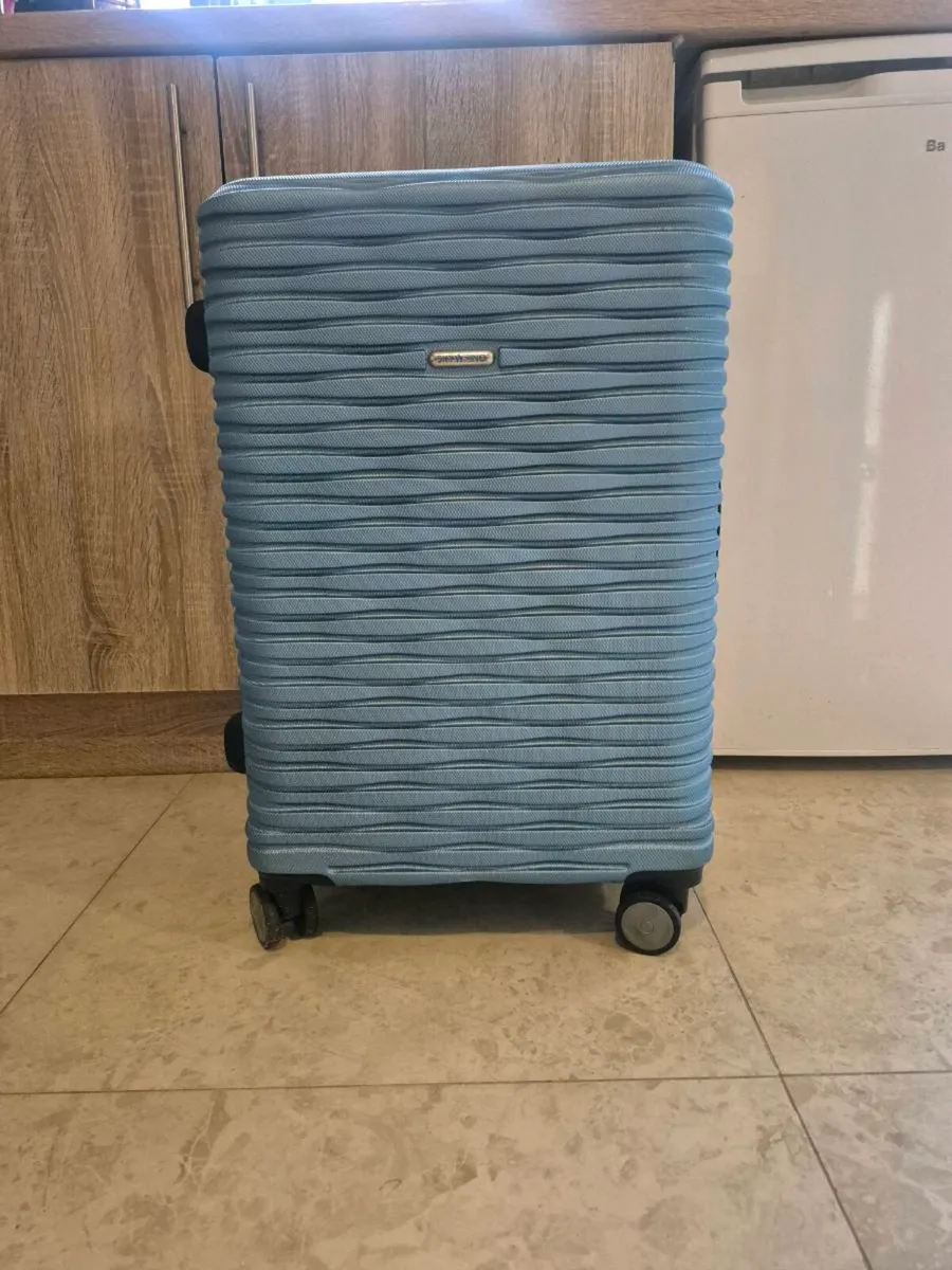 BLUE, HARDSIDE ROLLING SUITCASE FEATURING A DISTIN - Image 1