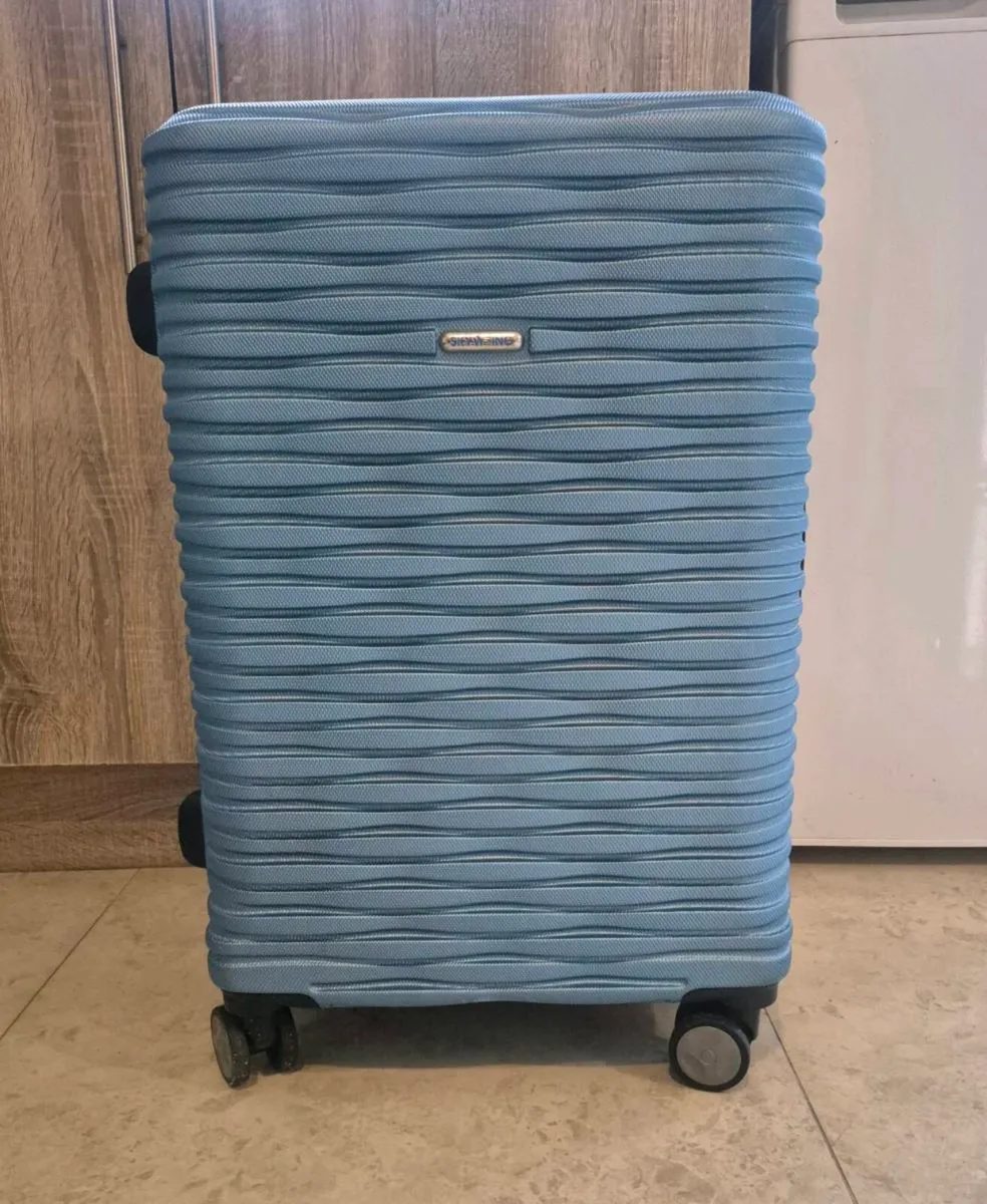 BLUE, HARDSIDE ROLLING SUITCASE FEATURING A DISTIN - Image 1