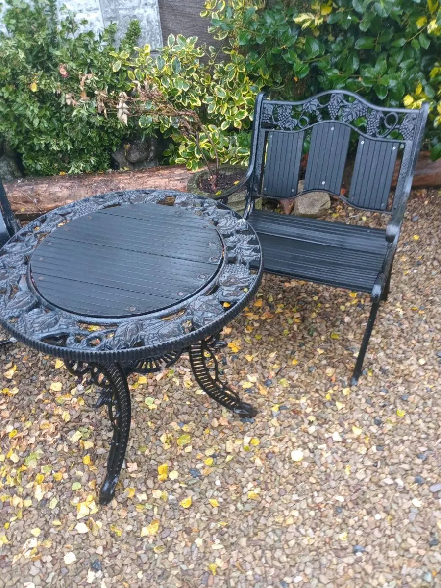 Cast iron table and chair - Image 1