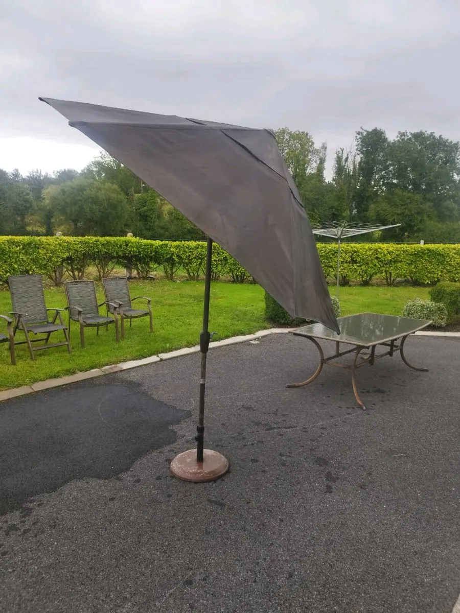 Outdoor table and chairs and umbrella. - Image 4