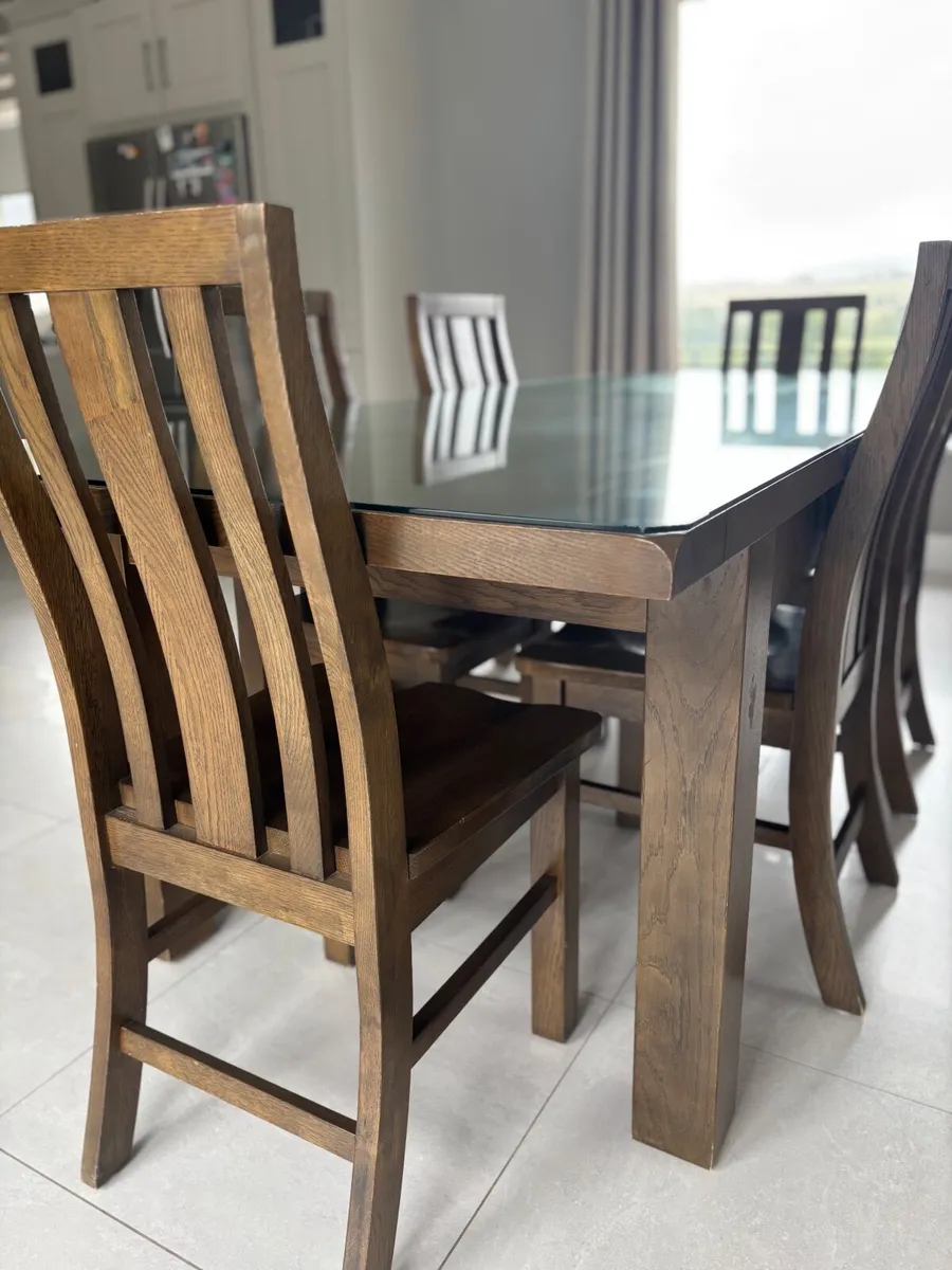 Dining table with glass top and 8 dining chairs - Image 1