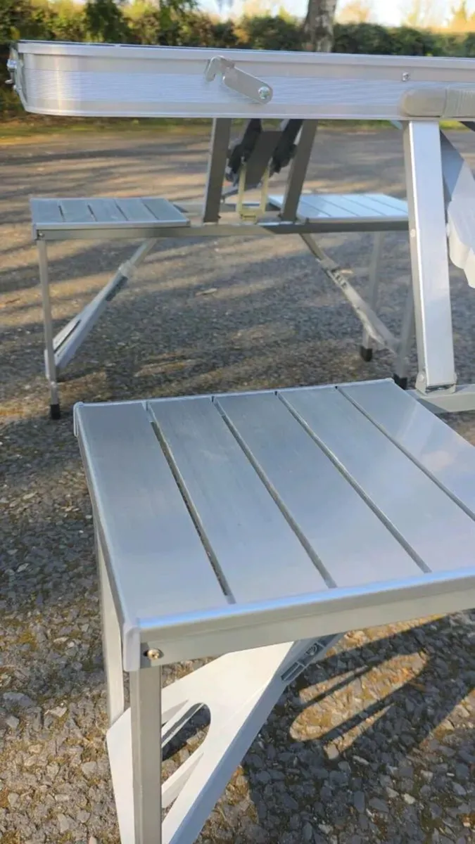 Foldable camping table with four seats. - Image 1