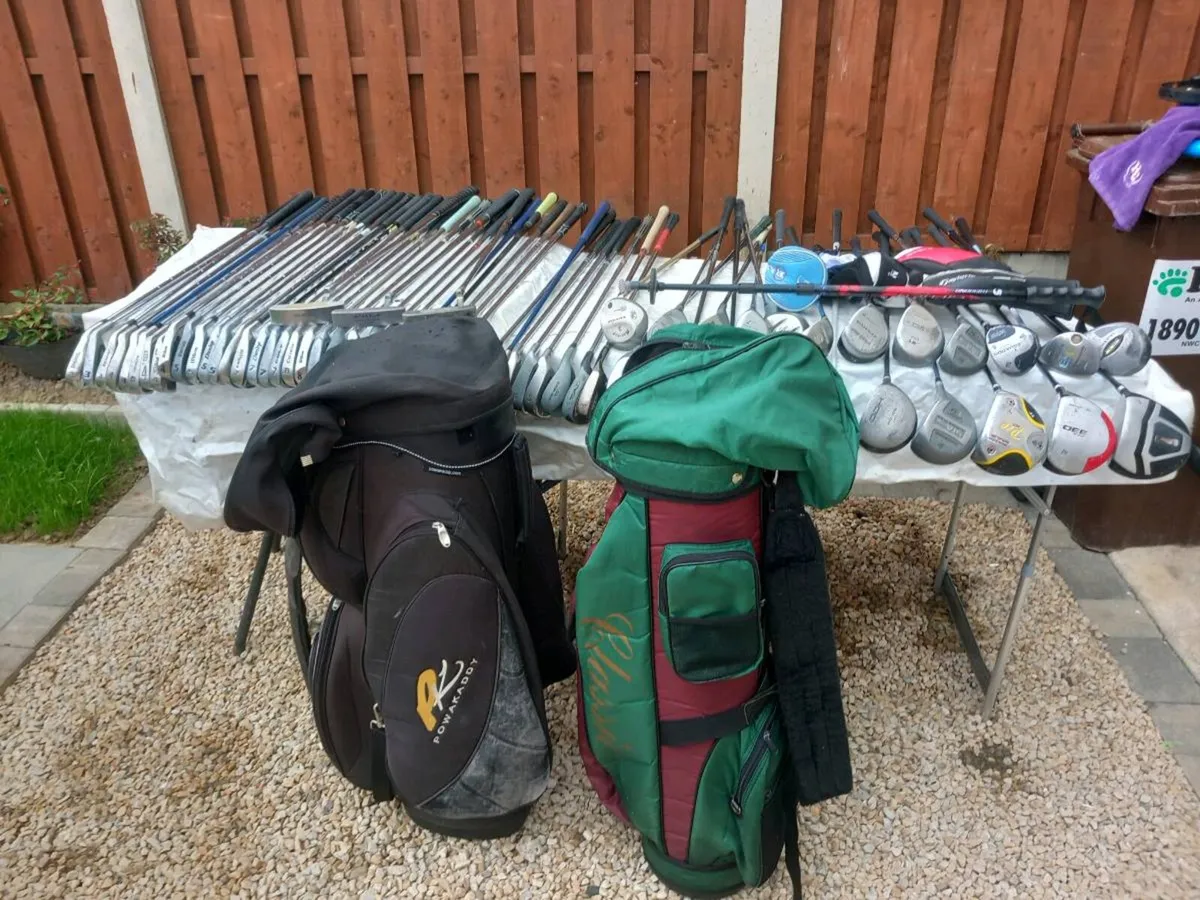 A selection of golf clubs and bags. - Image 1