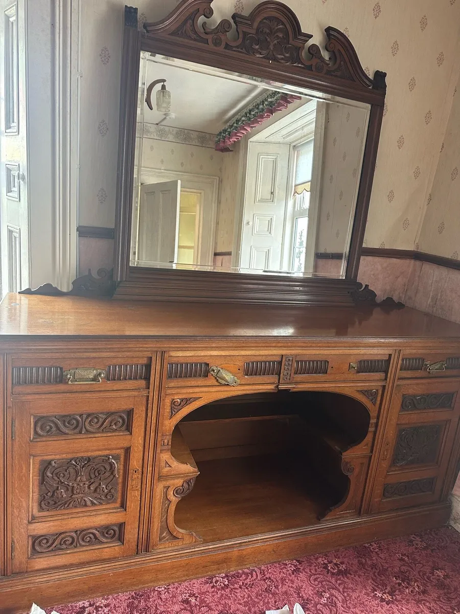 Antique carved sideboard with ornate mirror