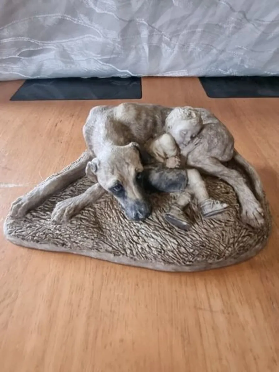 Sculpture of a boy sleeping with a dog - Image 1