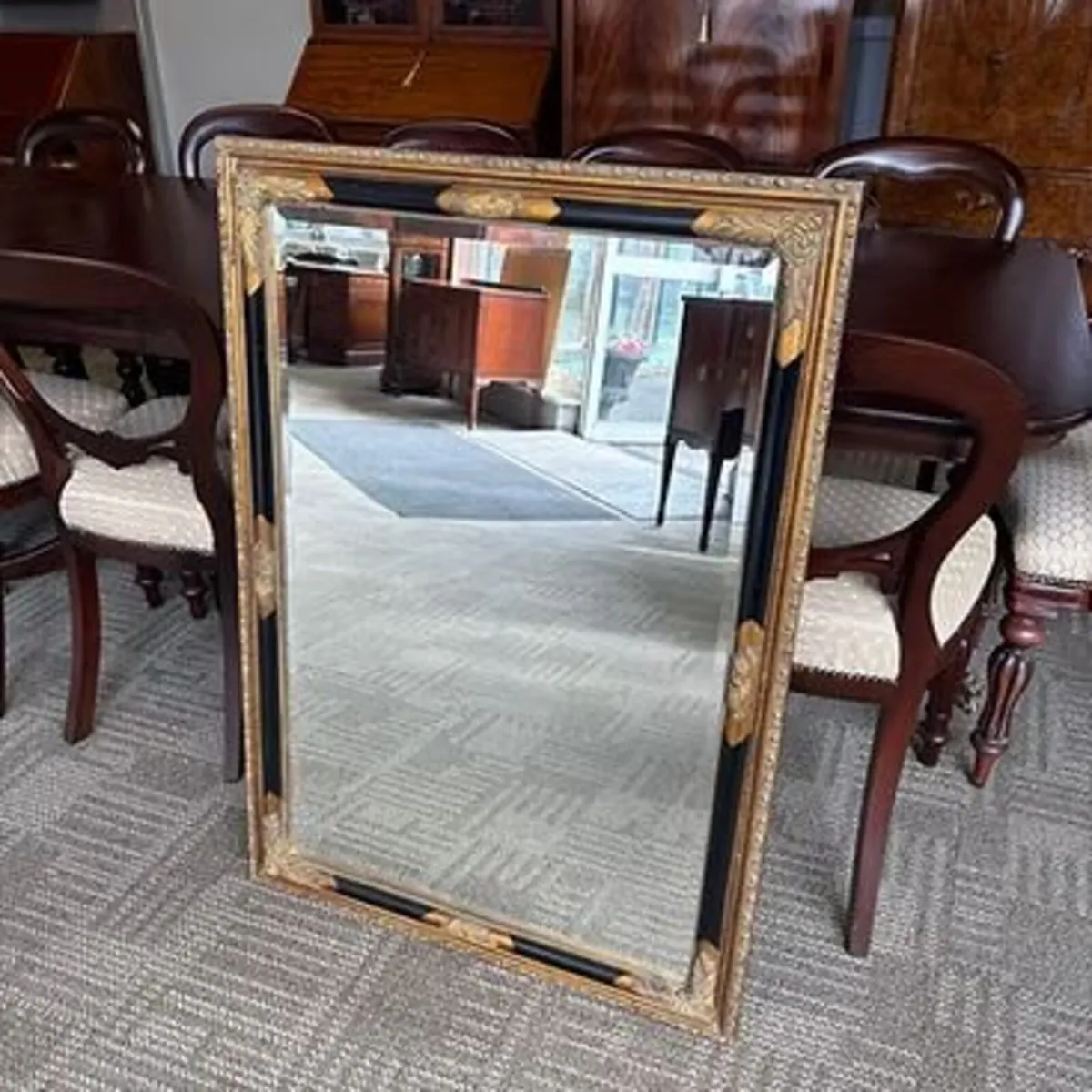 Rectangular wall mirror with a decorative gilt and