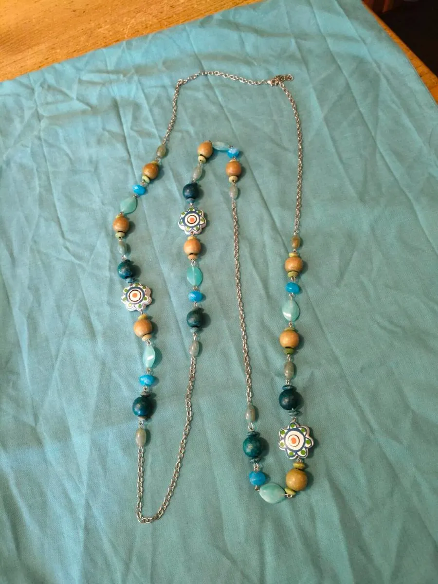 long, colorful beaded necklace featuring a mix of - Image 1