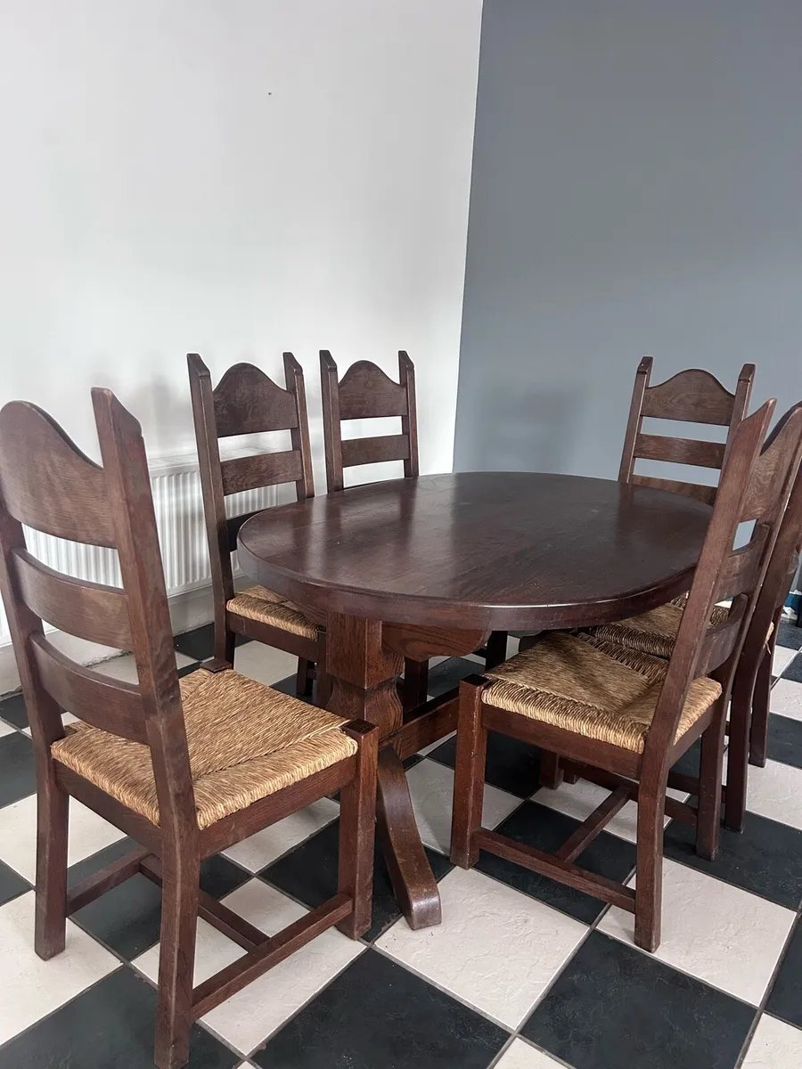 Oval solid wood dining table & 6 woven rush chairs - Image 1