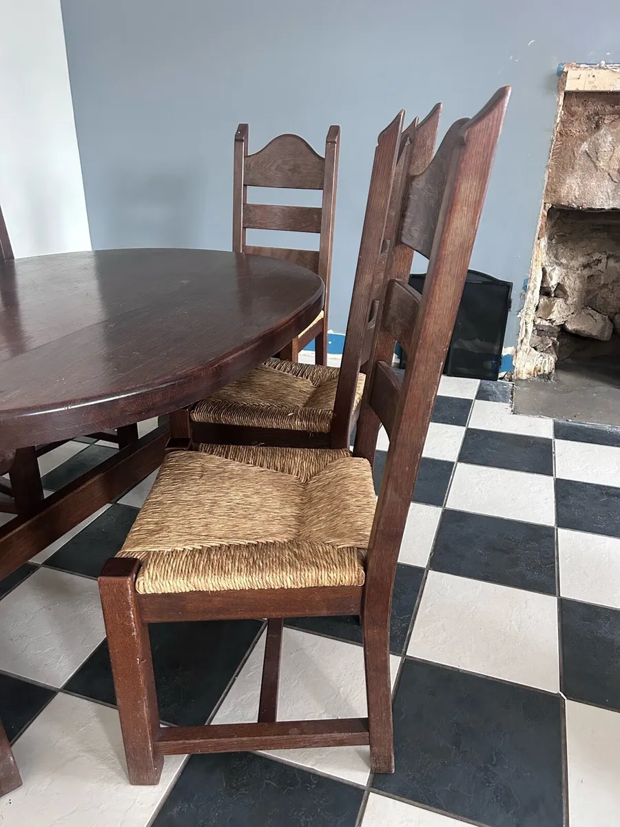 Oval solid wood dining table & 6 woven rush chairs - Image 3