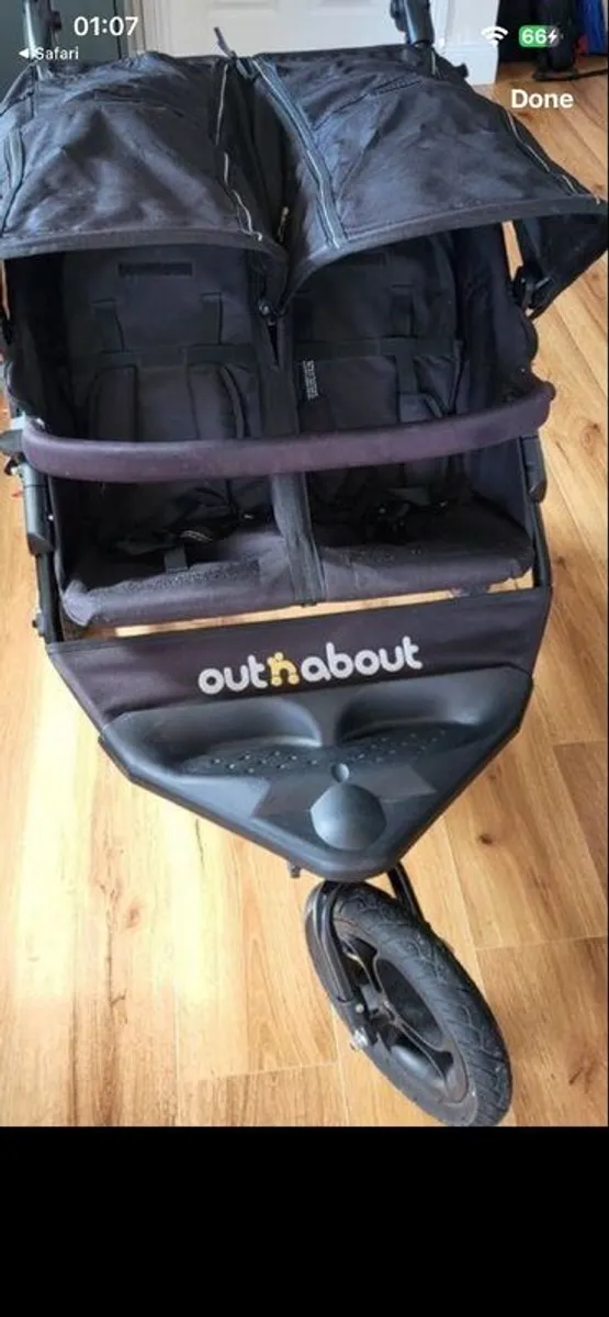 Out n about double buggy with raincover - Image 1